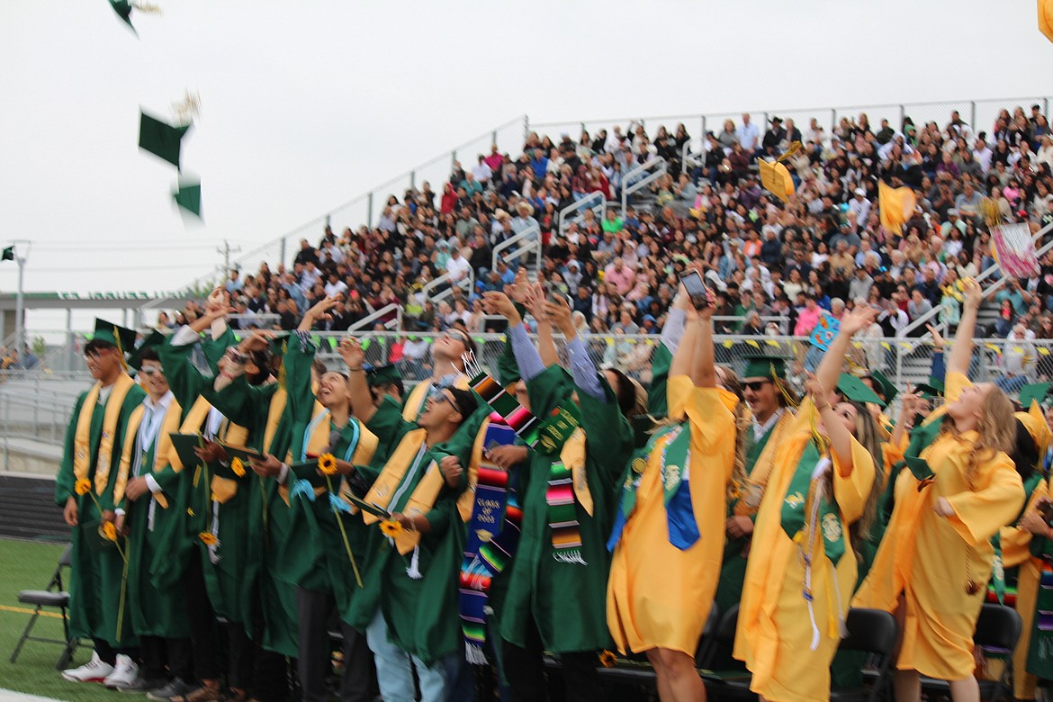 The class of 2023 celebrates their achievement with the traditional toss of graduation caps into the air at Quincy High School June 10.