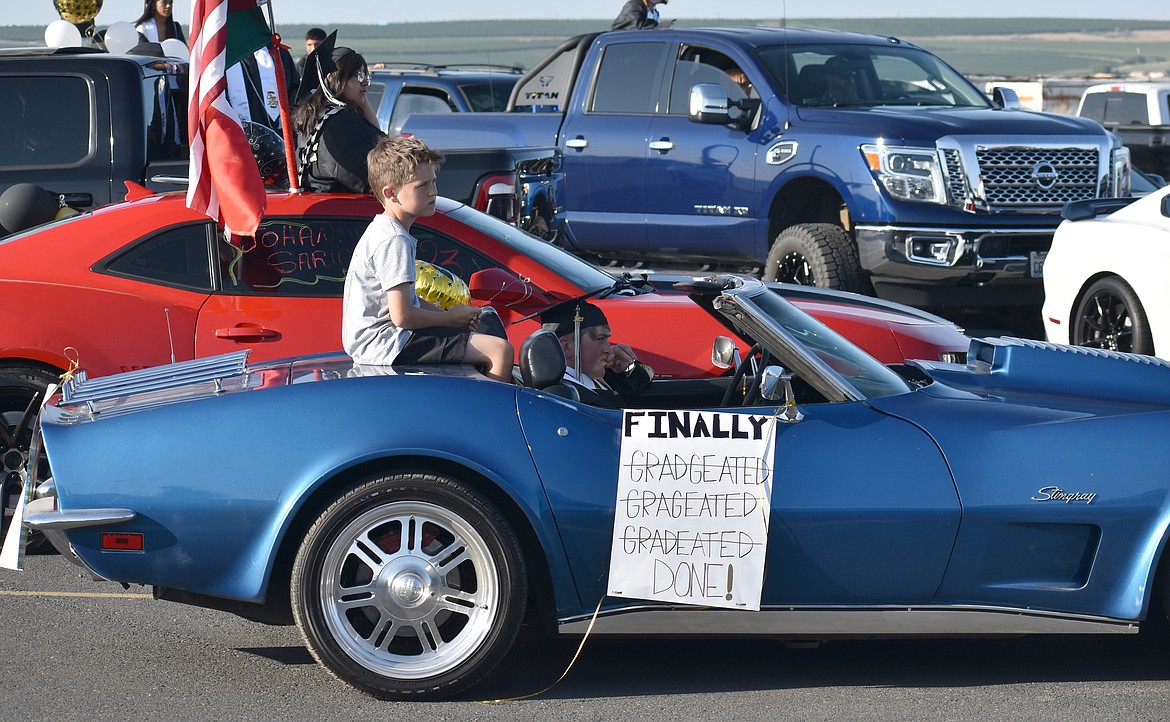 Nine-year-old Casen Andersen, left, and his cousin, Royal High School senior Carter Noftle, prepare to move out in Royal High School’s pre-graduation car parade June 2.