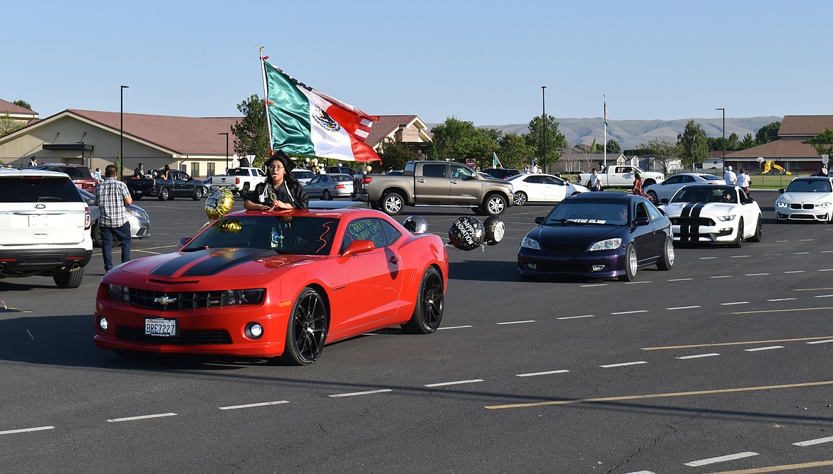 The car parade heads out of the Royal Intermediate School parking lot Friday to take a turn around town before the RHS seniors graduate.