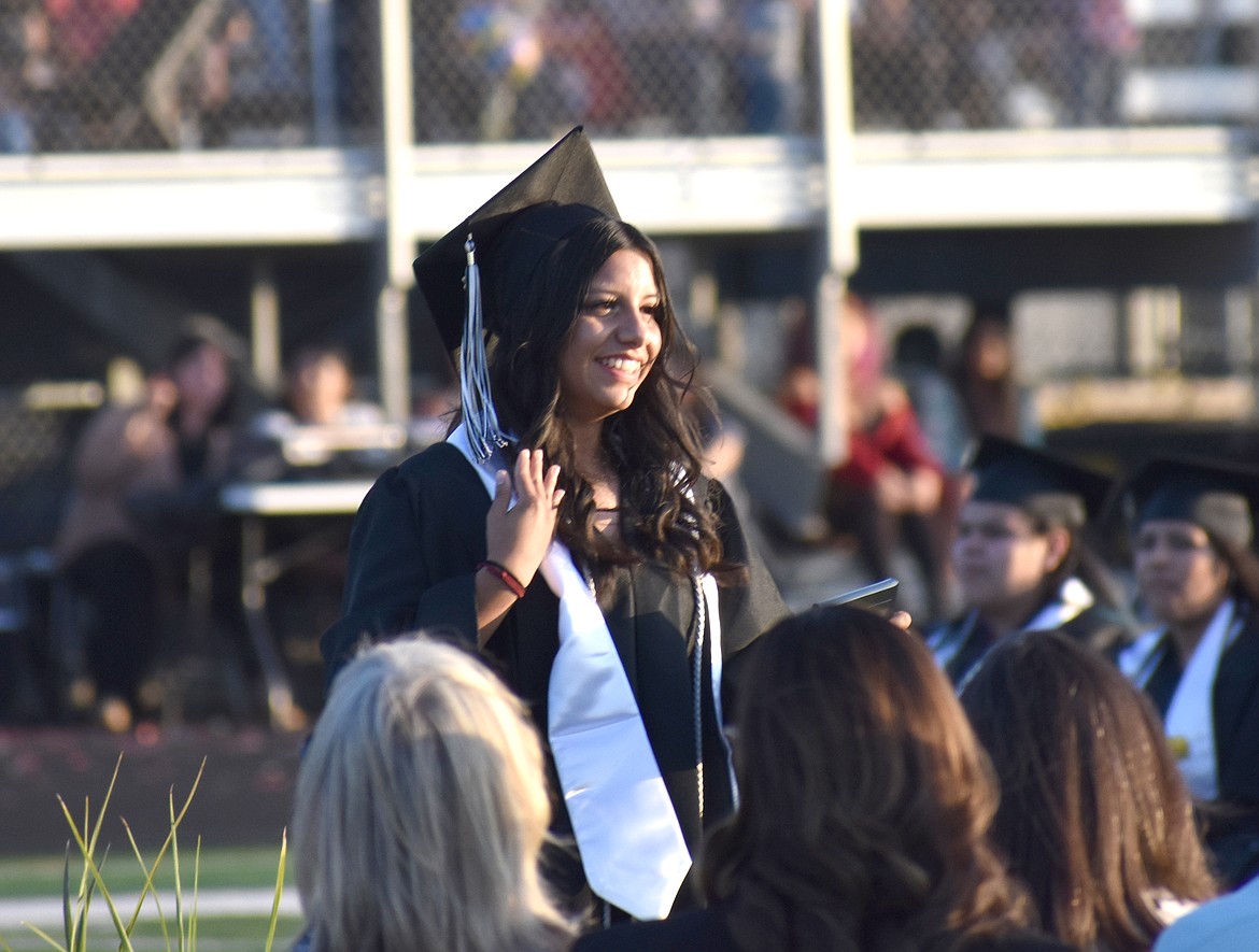 A new Royal High School graduate smiles at friends and family after the commencement ceremony June 2.