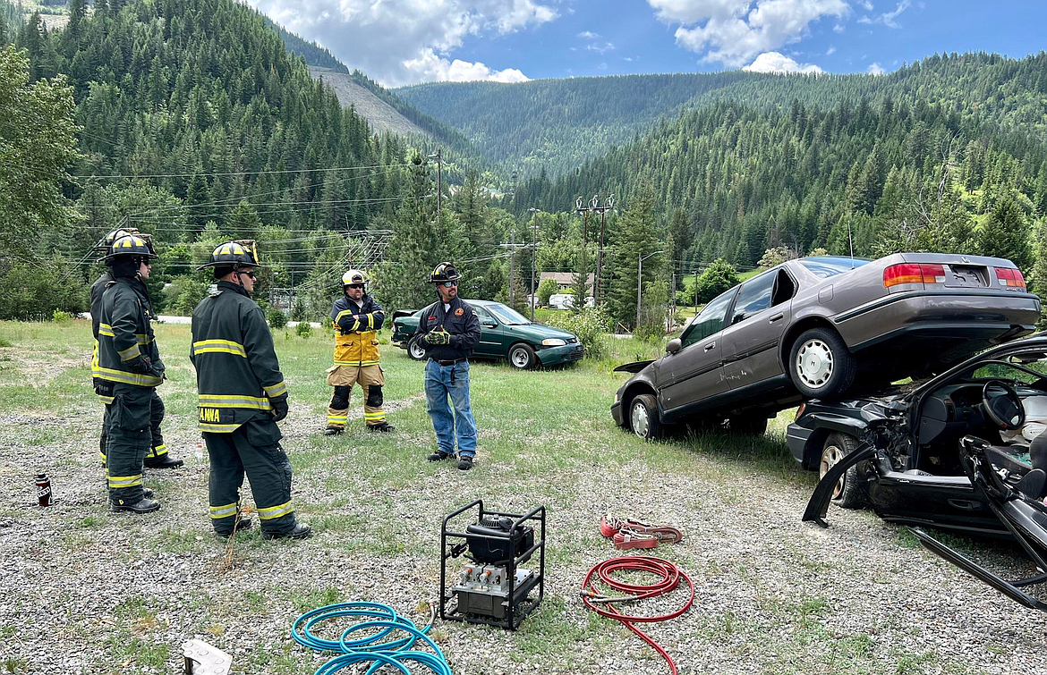 A trainer with Coeur FOOLS explains a simulated situation to a group of EMS personnel during SCFD1's vehicular extrication training last week. The two-day training covered a number of automobile accident scenarios and the 36 trainees were able simulate the processes required for successful extrication.