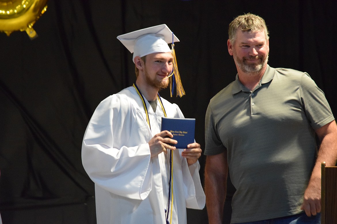 Wilson Creek High School graduate Ben Reitz receives his high school diploma during the school’s 2023 graduation ceremony June 3.