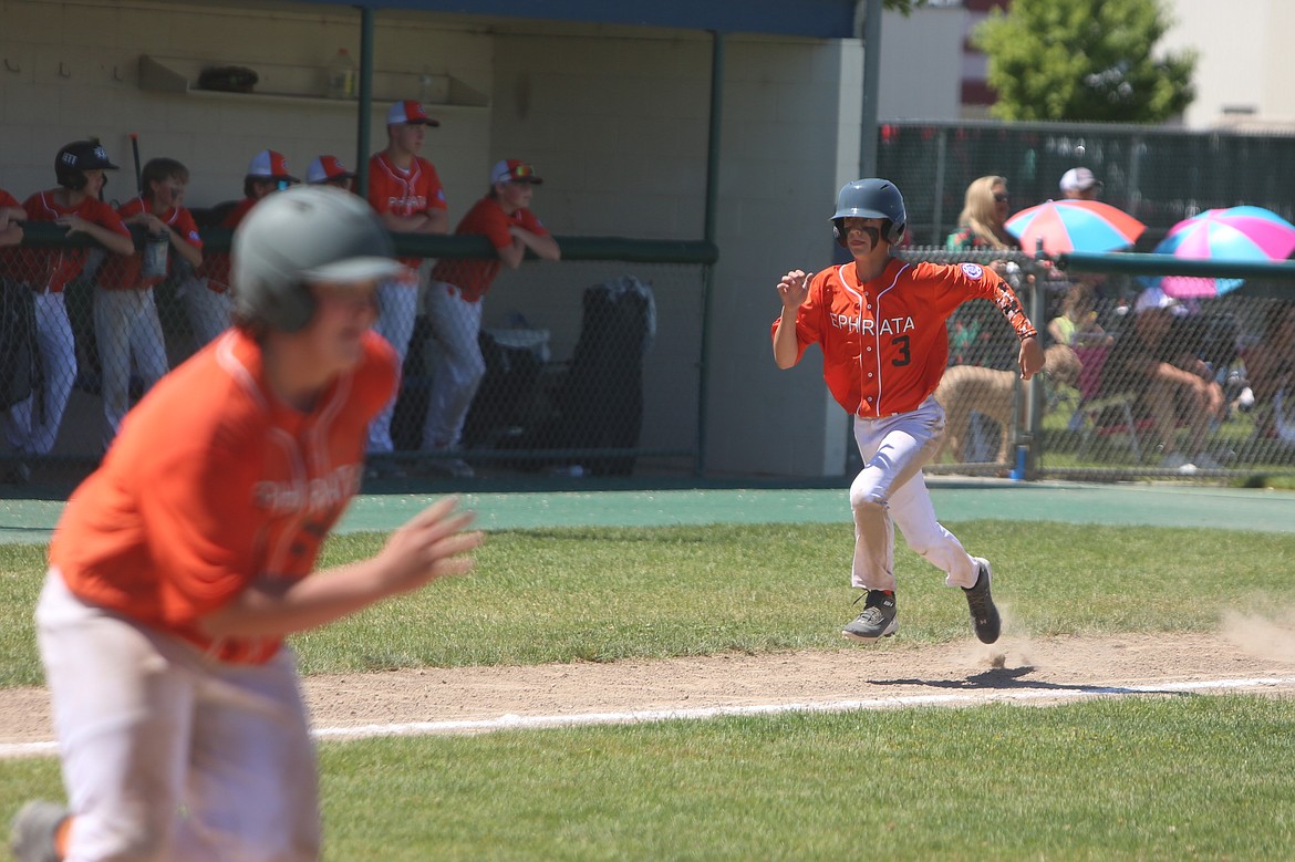 A 14U Ephrata baserunner advances to home plate off an RBI by a teammate.