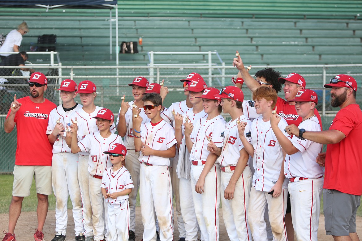 Players and coaches from the 13U Tri-Cities Spartans smile after winning the 13/14U division at the Pete Doumit Memorial Tournament. The Spartans defeated the 13U Columbia Basin Riverdogs in the title game.