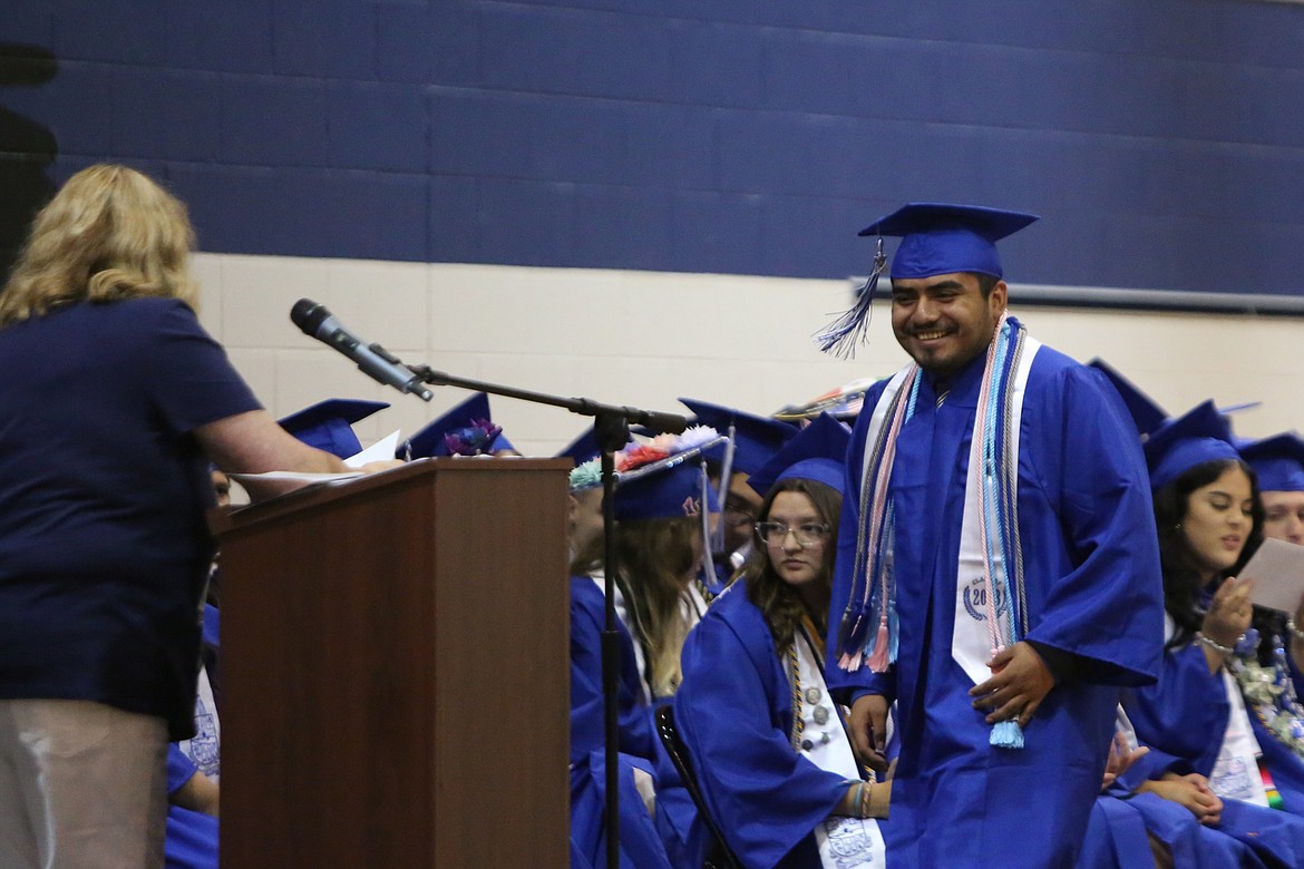 A Soap Lake High School senior walks up to the state to receive his scholarship from the Soap Lake Education Foundation.