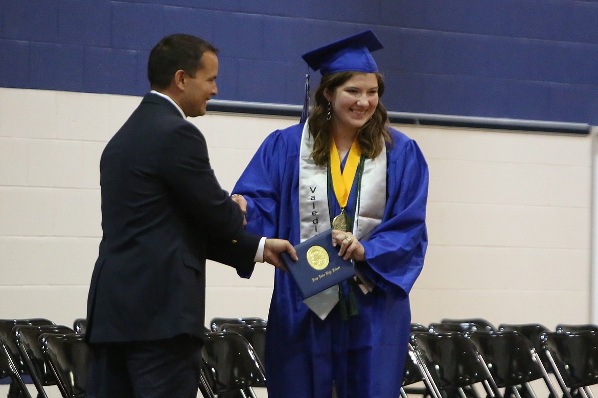 Soap Lake Valedictorian Zoe Alberti receives her diploma at Saturday’s Soap Lake High School graduation.