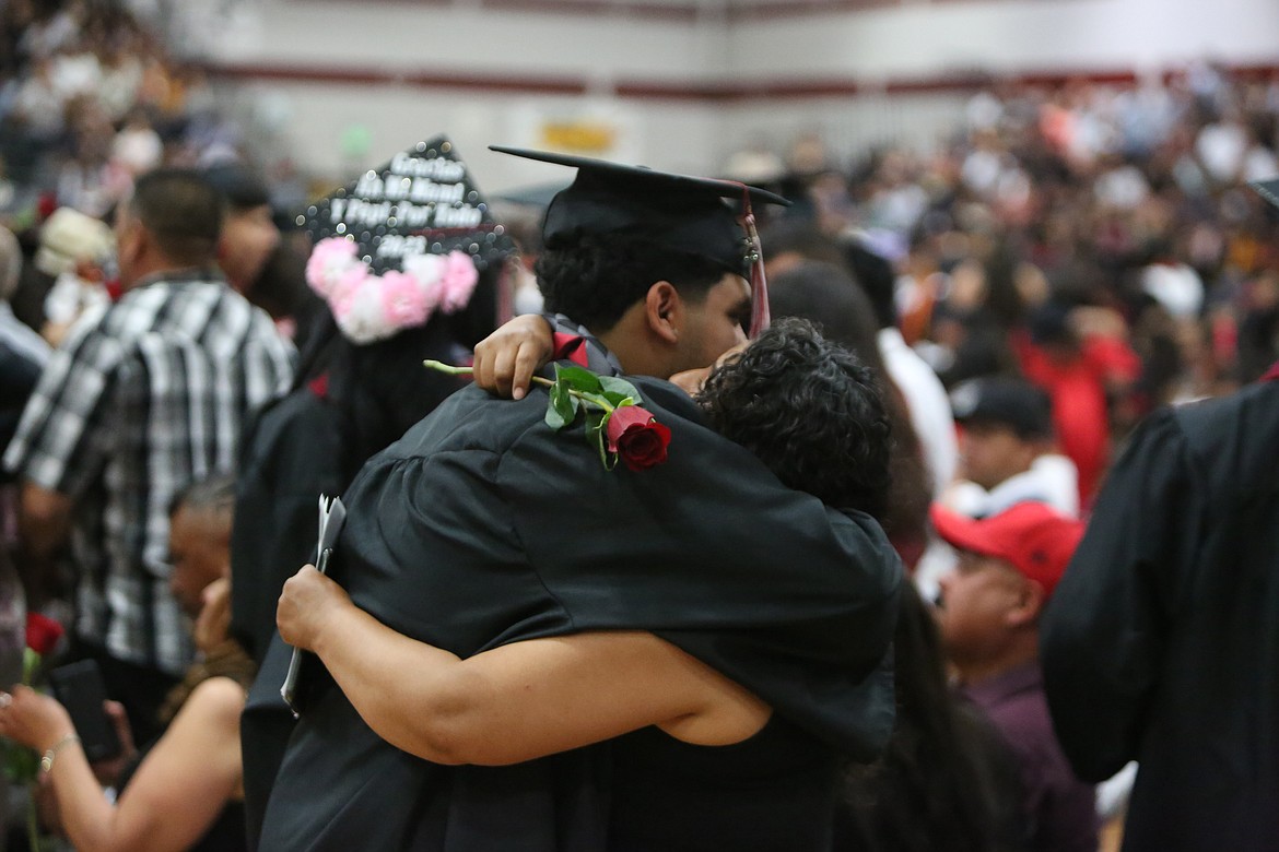 Wahluke High School graduates rose from their seats to pass out roses to loved ones in the crowd inside the gymnasium during the graduation ceremony on June 2.