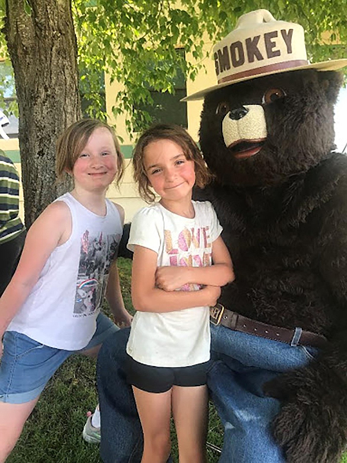 Smokey Bear gets his picture taken with a pair of students during a field trip to Idaho Hill Elementary School’s Safety Day on Wednesday, June 7. Idaho Department of Lands along with the U.S. Forest Service brought engines and firefighters to show the schoolkids parts of their jobs which include helping Smokey with his message of personal responsibility.