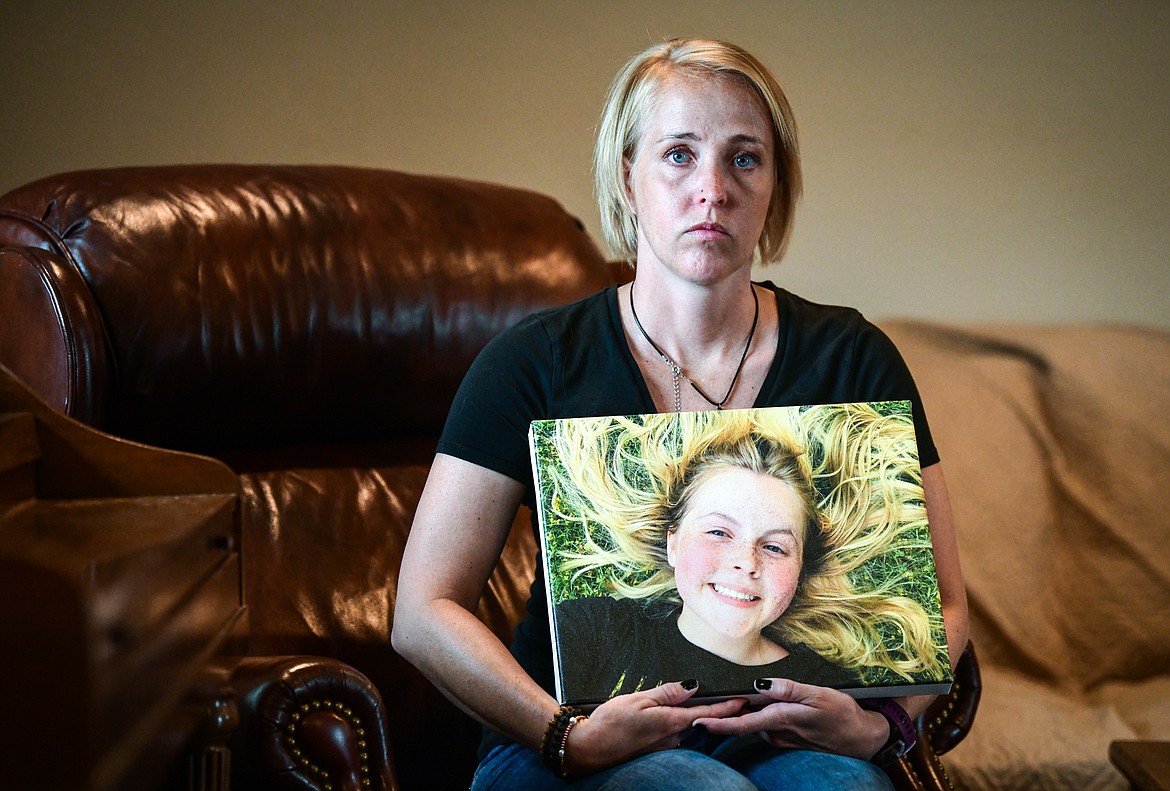 Julie Knapp poses for a portrait in her Kalispell home on June 14, holding a photo of Juniper Knapp, her daughter, who accidently overdosed on fentanyl in May. (Casey Kreider/Daily Inter Lake)