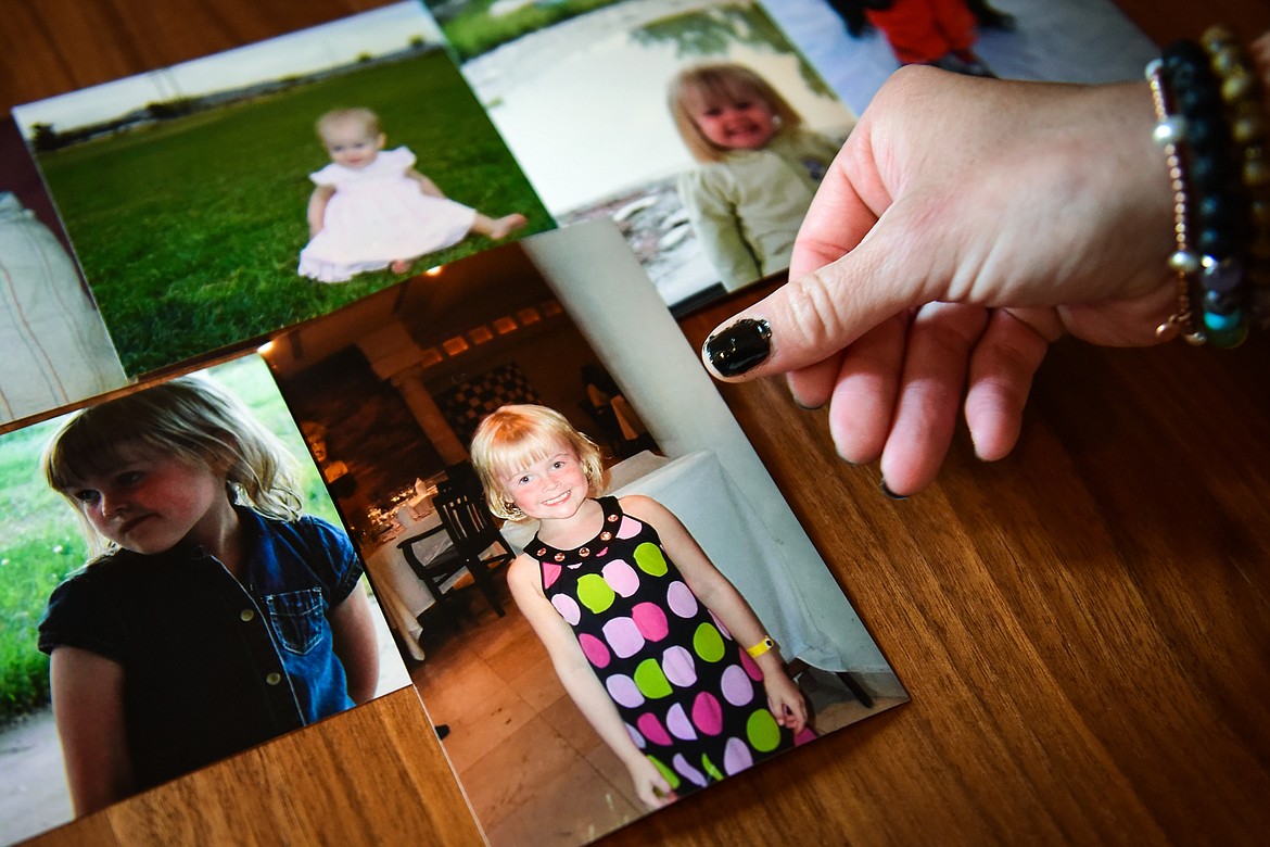 Julie Knapp shows photos throughout her daughter Juniper Knapp's life. Juniper accidently overdosed on a pill laced with fentanyl in May. (Casey Kreider/Daily Inter Lake)