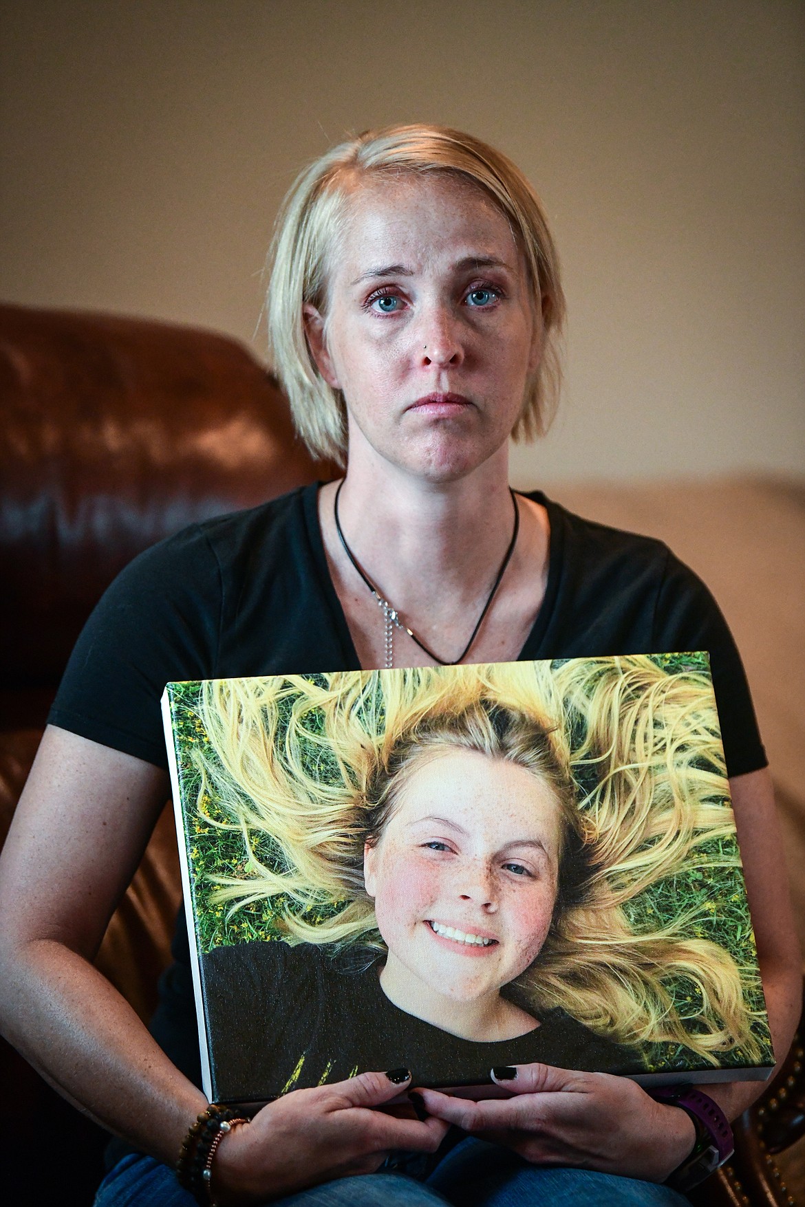 Julie Knapp poses for a portrait in her Kalispell home on June 14, holding a photo of Juniper Knapp, her daughter, who accidently overdosed on fentanyl in May. (Casey Kreider/Daily Inter Lake)