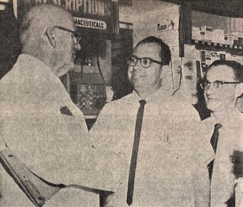 Druggist Victor Wilson of iconic Wilson’s Pharmacy, left, is shown with buyers Charles Sears, center, and Mickey Holovka.