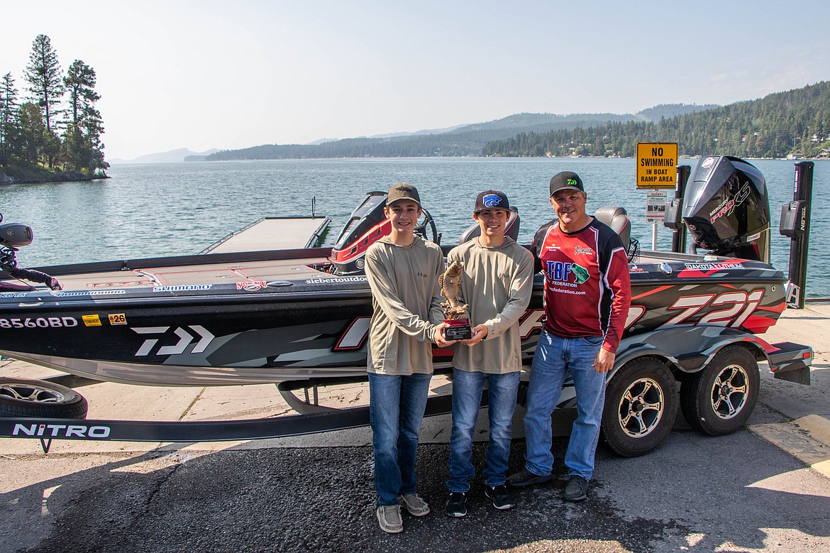 Christian Rensel and Drake Dawson, with their coach Randy Siemens, pose for a portrait at the Somers boat launch on June 13, 2023. (Kate Heston/Daily Inter Lake)