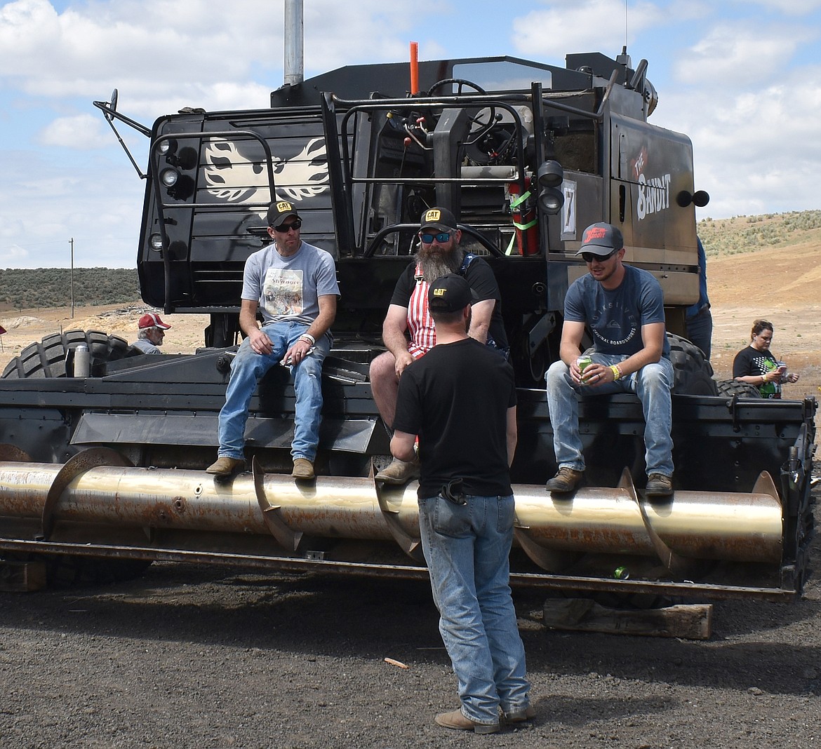 From left: Dan Sims, Dustin Wilson and Cody Kulm sit on the front of The Bandit and talk with Travis Punchello before the Lind Combine Derby Saturday.