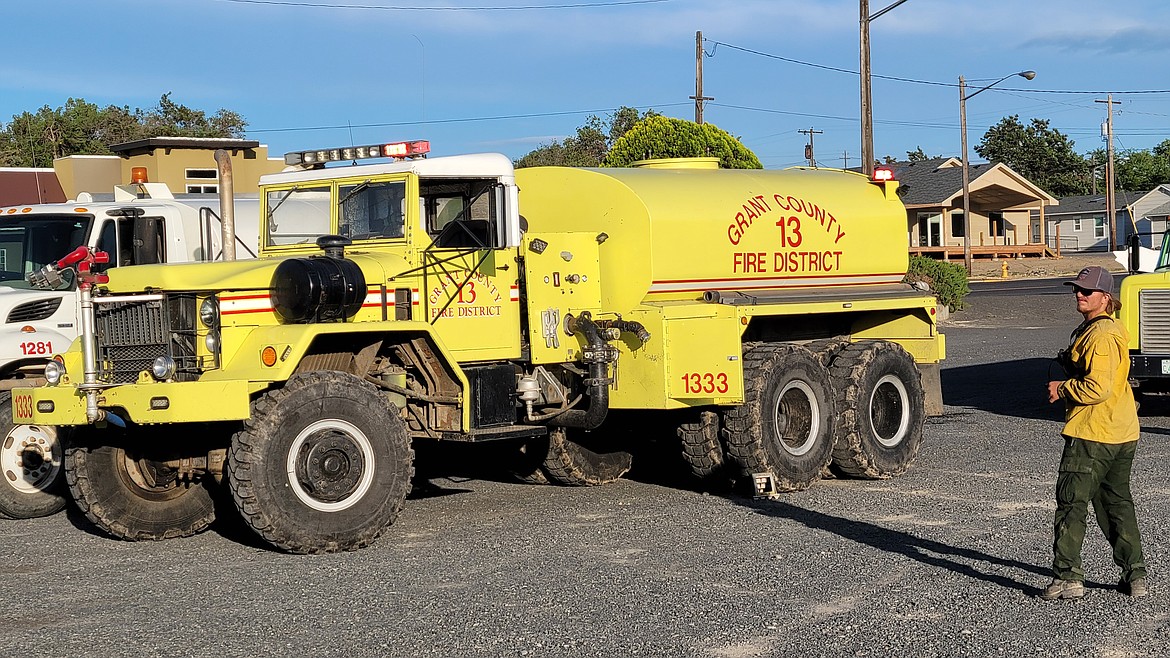 A firefighter moves to get back in his truck outside of a command station set up at East Beach Park in Soap Lake for a fire that occurred just north of Soap Lake Tuesday afternoon. The fire burned about 50 acres.