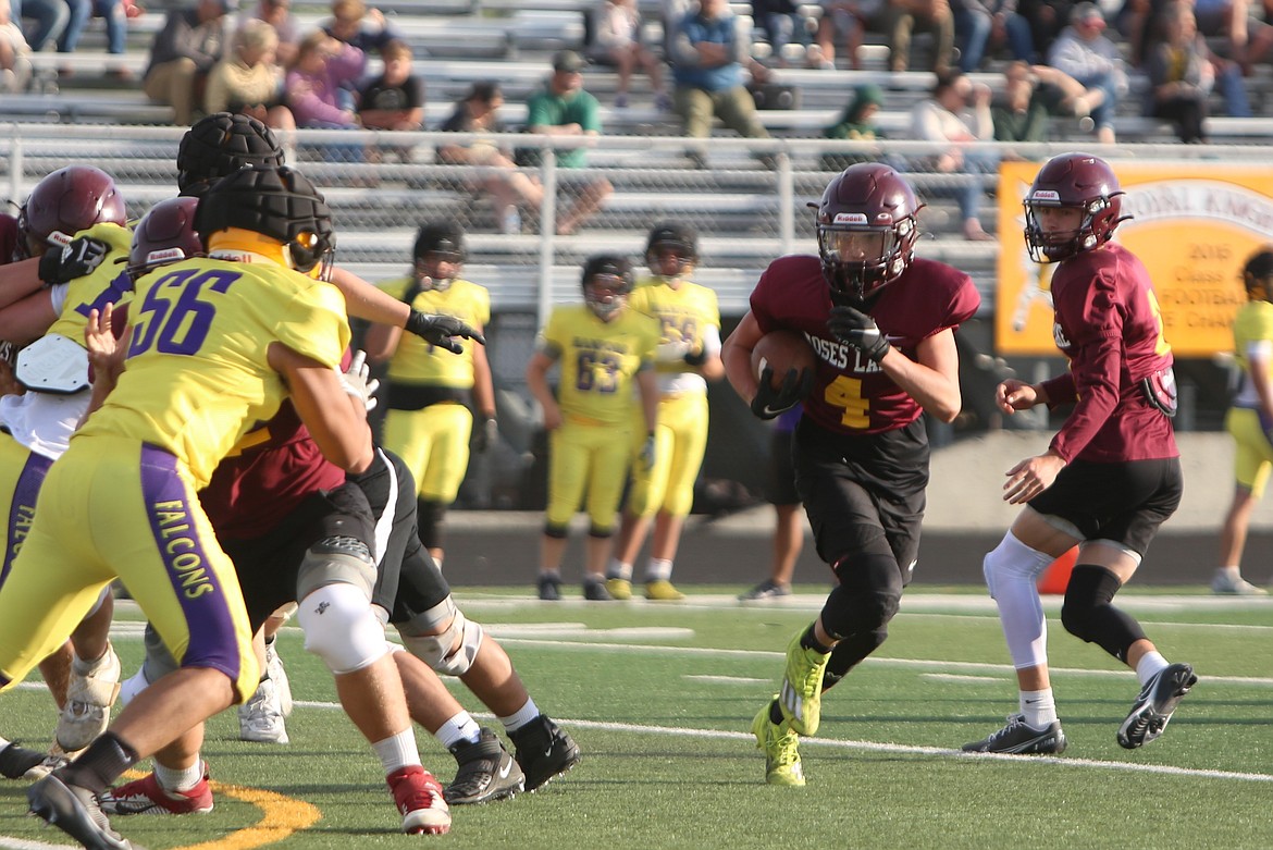 A Moses Lake running back rushes to the left against the Hanford defense.