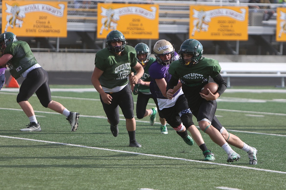 The Quincy offense moves upfield against the Connell defense at Tuesday’s scrimmage in Royal City.