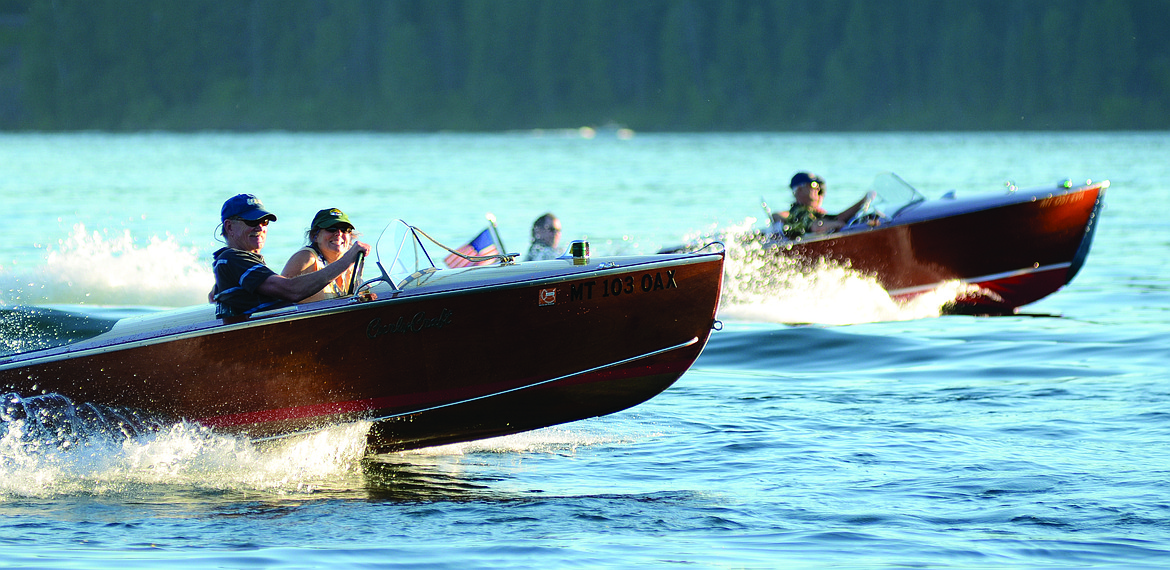 Wooden boats zip across Whitefish Lake. (Whitefish Pilot FILE)