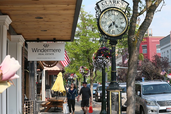 A couple peers into shop windows on a sunny afternoon on June 15 during a walk along Sherman Avenue in downtown Coeur d'Alene. Small businesses play a significant role in Coeur d'Alene, along with every other North Idaho community.