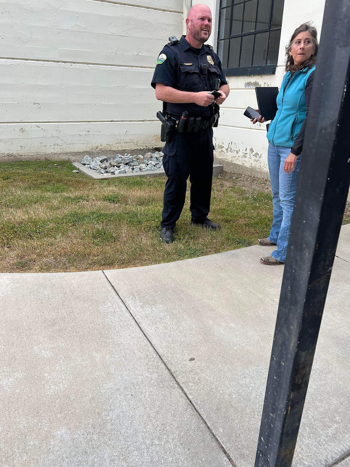 Priest River Police Chief Drew McLain talks to Heather Scott outside Priest River Junior High School. The police chief escorted the District 1 legislator out of the school auditorium following a possible incident with a parent following a volatile school board meeting Wednesday.