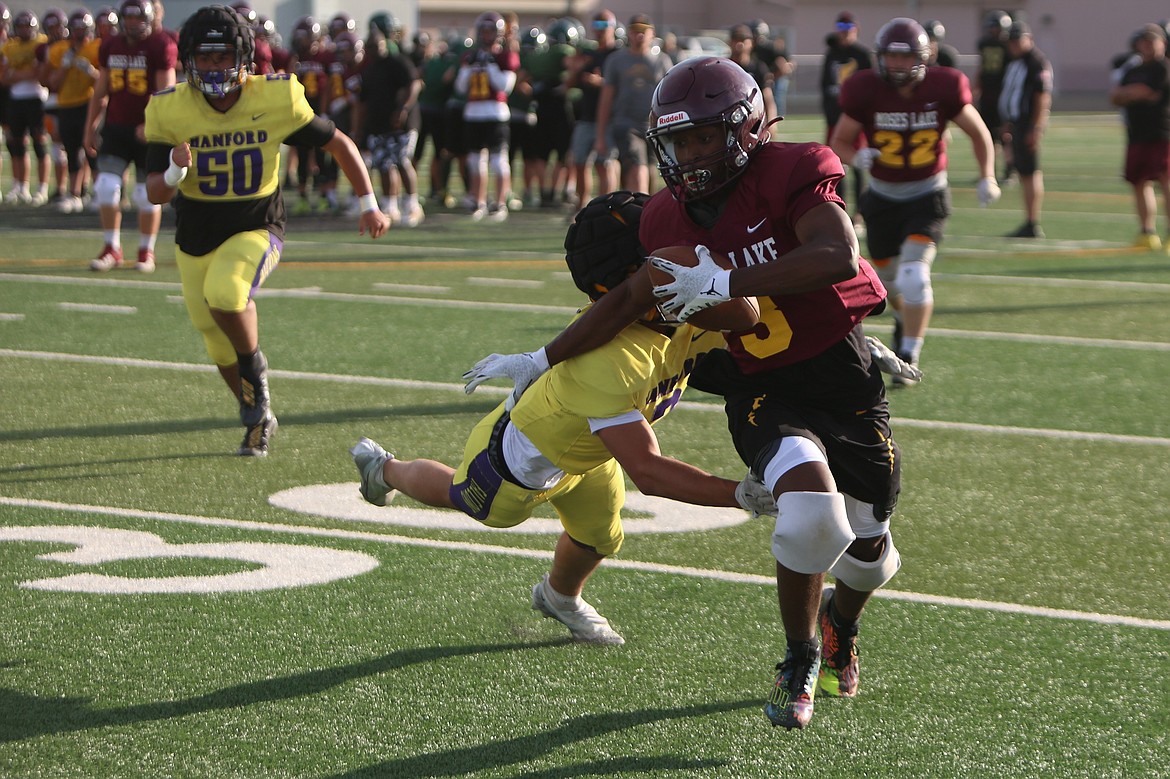 Moses Lake receiver Joel Middleton (3) pushed off a Hanford defender at Tuesday’s scrimmage in Royal City.