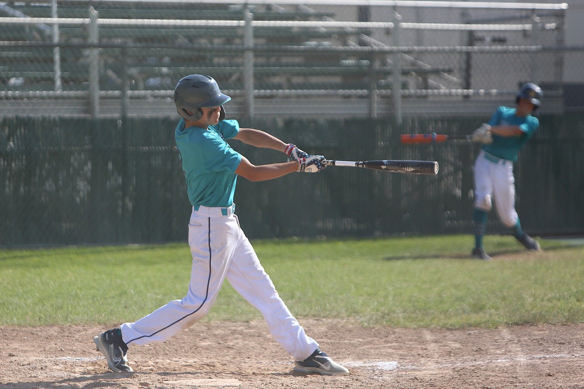 A batter for the 13U Columbia Basin River Dogs swings at a pitch against the Tri-Cities Spartans at the Pete Doumit Memorial Tournament on Sunday.