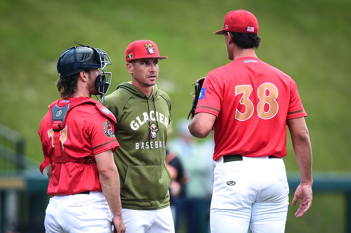 Glacier pitching coach Zach Stewart talks to starting pitcher Nick Zegna (38) on the mound against the Missoula Paddleheads on Friday, June 16. (Casey Kreider/Daily Inter Lake)