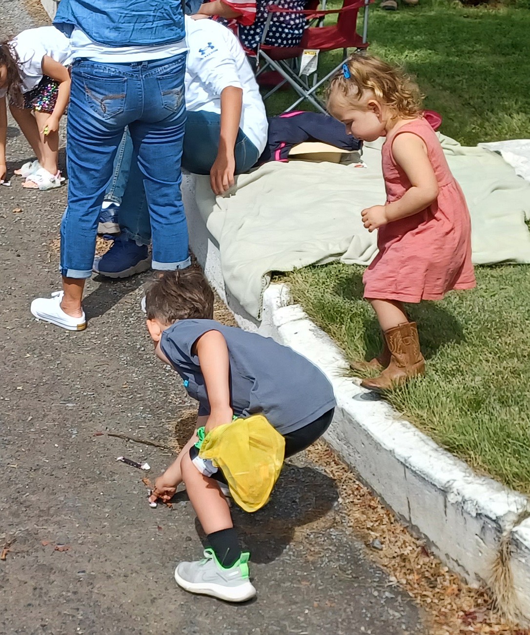 Children scoop up candy during the 2022 Fourth of July at George parade.