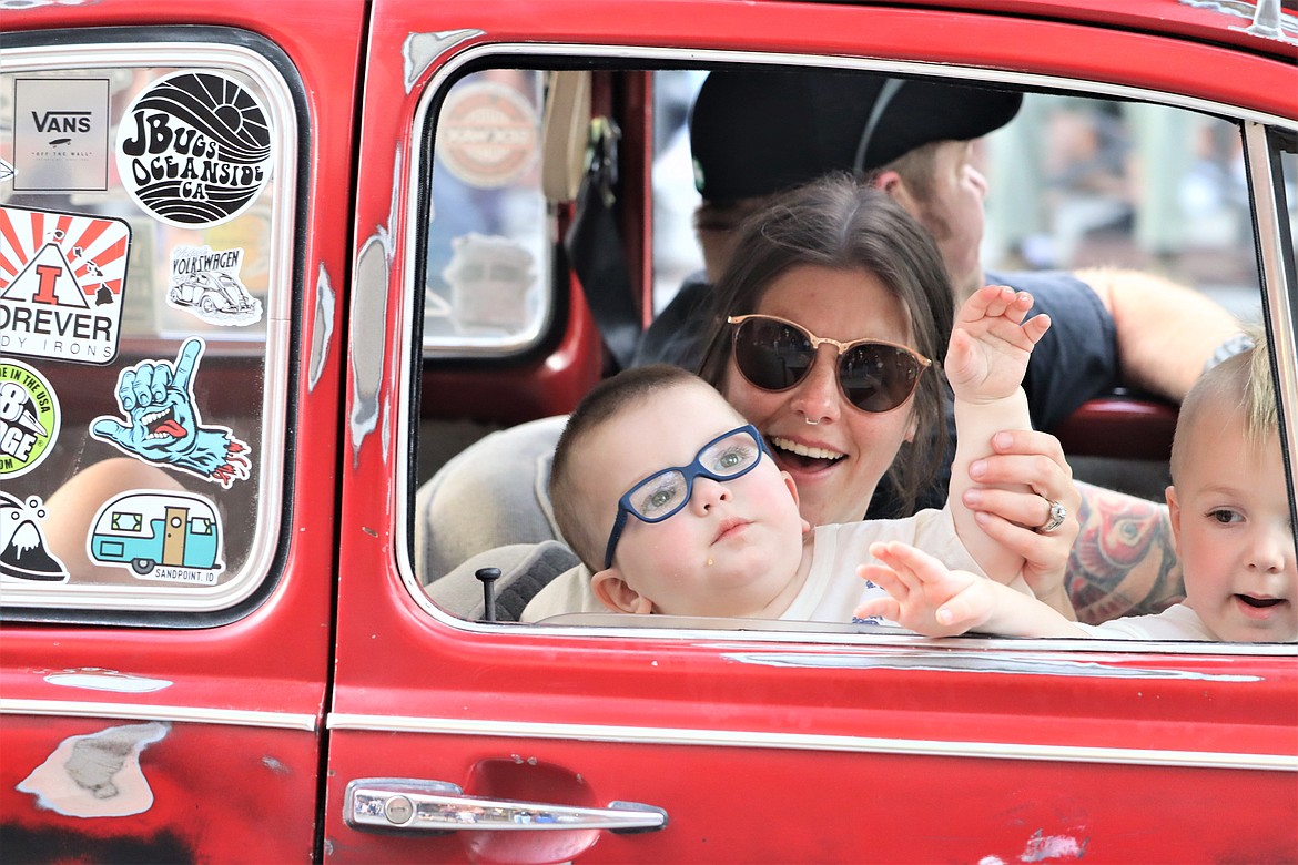 Ashley, Jax and Axel Matue of Post Falls wave and smile from their 1970 Volkswagen Beetle during Car d'Lane.