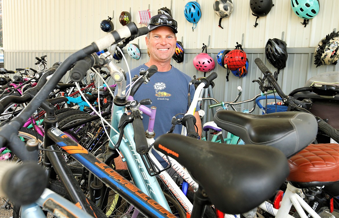 Corey Ray poses among some of about 40 bikes he repaired at Children's Village during Windermere Realty Coeur d'Alene's Community Service Day on Friday.