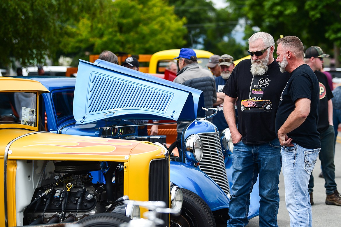 Visitors check out rows of classic and custom vehicles at The Big Shindig outside The DeSoto Grill in Kalispell on Saturday, June 17. The Big Shindig also features live music, barbeque, beer and wine and a pin-up polar plunge. Hosted the Glacier Street Rod Association and the Desoto Grill, money raised benefits Mikayla’s Miracles and Blessings Foundation.