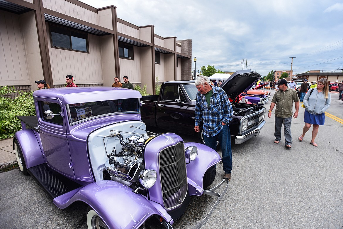 Visitors check out rows of classic and custom vehicles at The Big Shindig outside The DeSoto Grill in Kalispell on Saturday, June 17. The Big Shindig also features live music, barbeque, beer and wine and a pin-up polar plunge. Hosted the Glacier Street Rod Association and the Desoto Grill, money raised benefits Mikayla’s Miracles and Blessings Foundation.