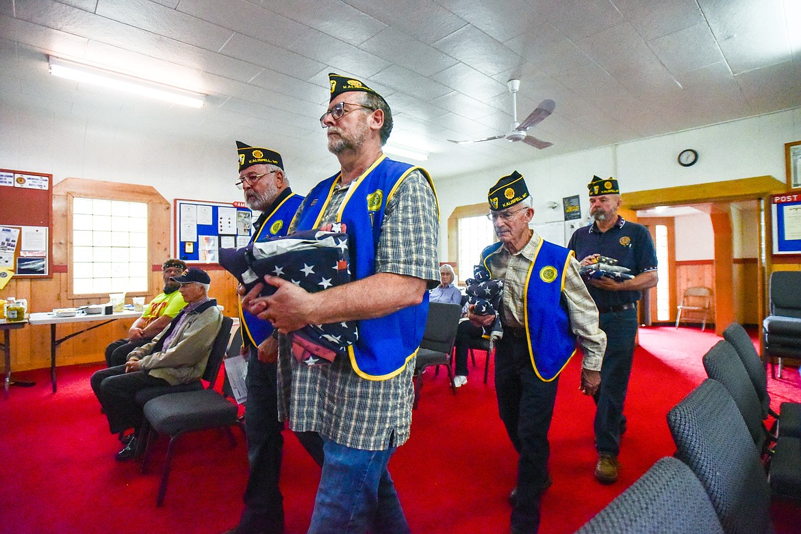 Members of Kalispell American Legion Post 137 and Auxiliary Unit 137 hold a flag retirement ceremony to respectfully dispose of worn, tattered and faded American flags outside their headquarters on Saturday, June 17. (Casey Kreider/Daily Inter Lake)