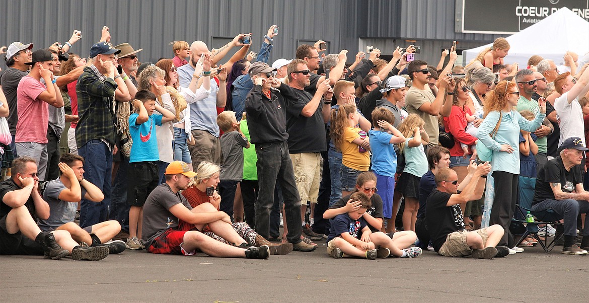 Crowd members take pictures and plug their ears as the F-35s prepare for takeoff on Saturday at the Coeur d'Alene Airport.