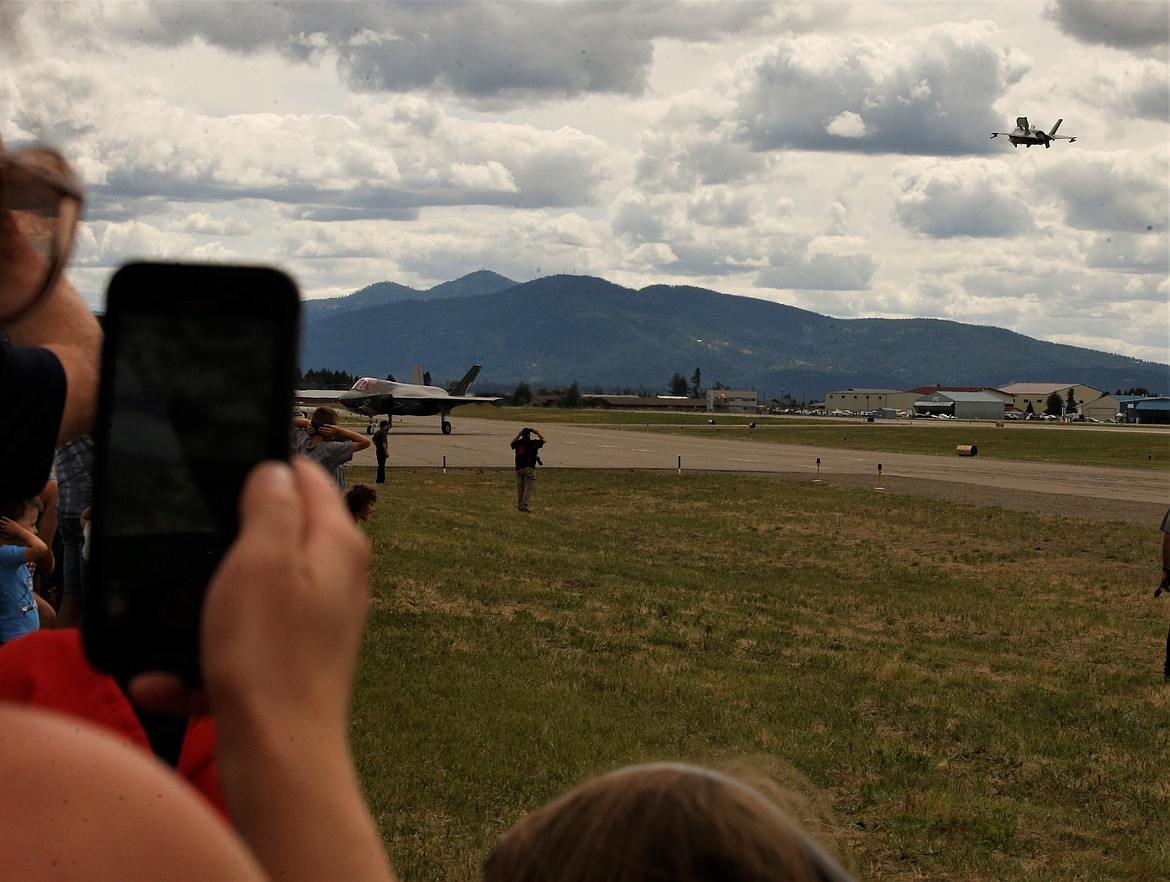 People record the departure of an F-35 as it soars away from the Coeur d'Alene Airport on Saturday.