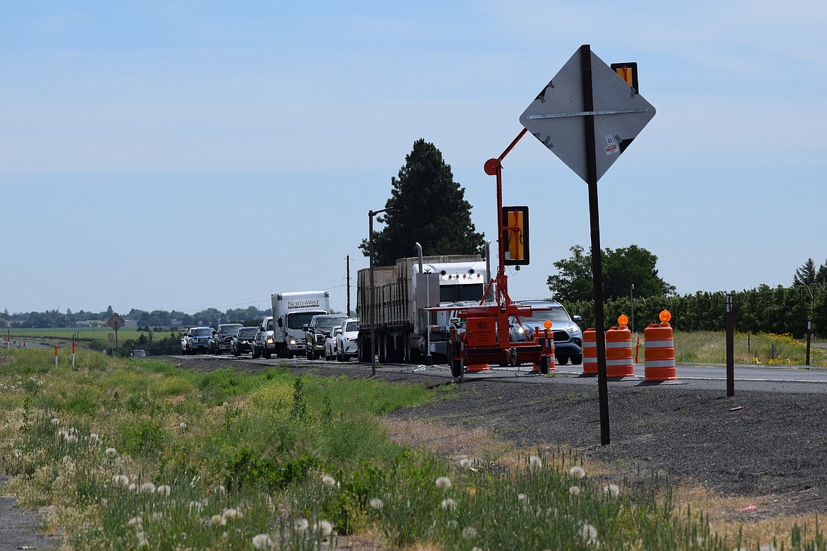 Traffic waits for the portable traffic light at the new roundabout at White Trail Road west of Quincy. The Washington State Department of Transportation has announced the roundabout will fully open June 26.