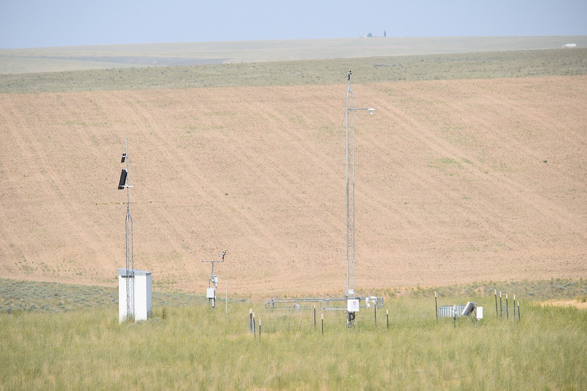 Instruments gather weather data on a cool but hazy day amidst the wheat trial plots at Washington State University’s Lind Dryland Research Station on Thursday.