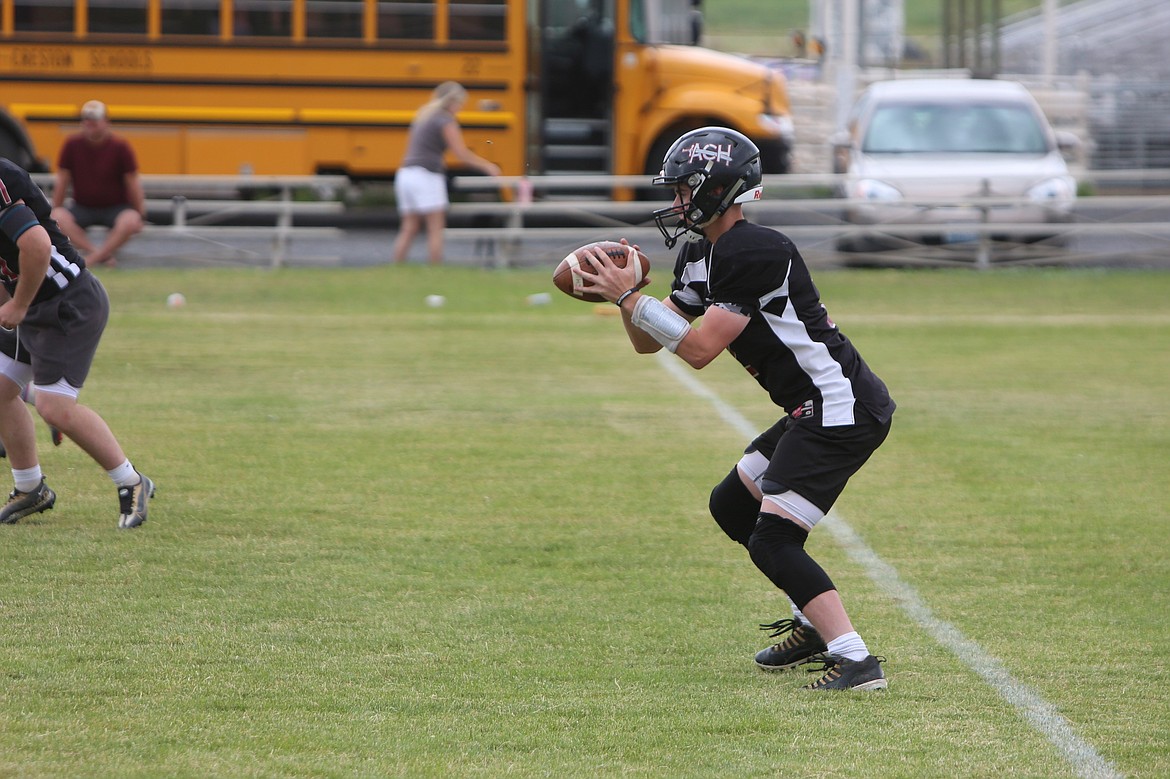 An ACH quarterback takes the snap against the Soap Lake defense at Friday’s jamboree.