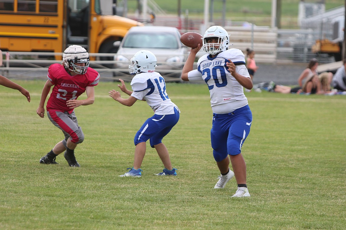 A Soap Lake quarterback throws a pass to his left against the Waterville-Mansfield defense.