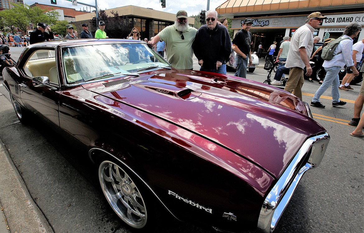 James Burns, right, is joined by son Rob Burns by his 1968 Pontiac Firdbird at the Car d'Lane car show Saturday in downtown Coeur d'Alene.