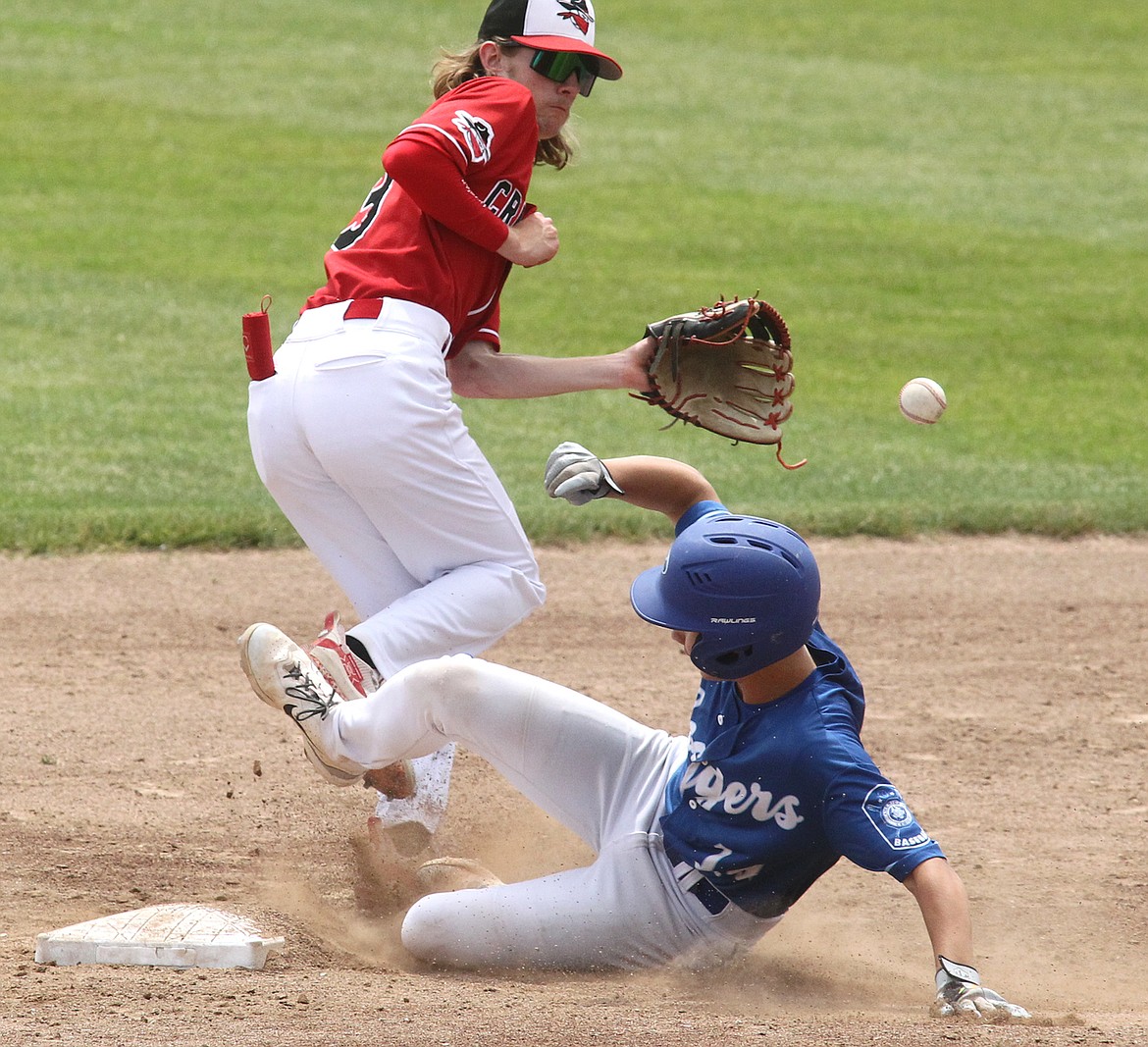 Libby Loggers Legion player Brody Gilmore slips under the throw to Cranbrook Bandits second baseman Brantley Johnson to steal second base in the bottom of the second inning in the first game of a doubleheader Saturday at Lee Gehring Field. The Bandits won, 10-4. (Paul Sievers/The Western News)