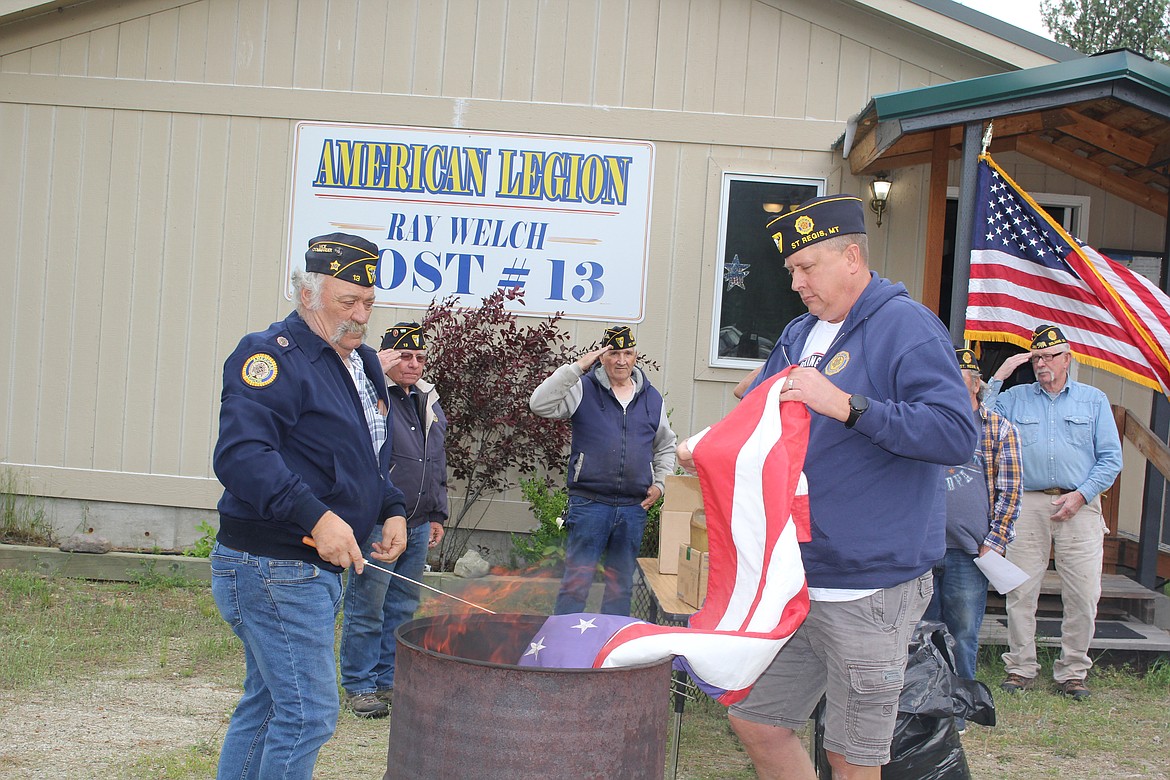 American Legion members Dave Carrott, left and Joe Griffith were responsible for the fire pit for proper disposal of American and Montana state flags on June 14. (Monte Turner/Mineral Independent)