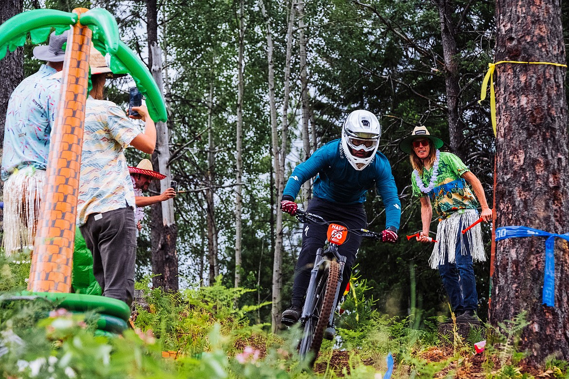 A racer cruises down a trail on Silver Mountain as people look on in awe during the North American Eduro Cup race. 2023 was the seventh year that Silver Mountain has been involved in the national race circuit.