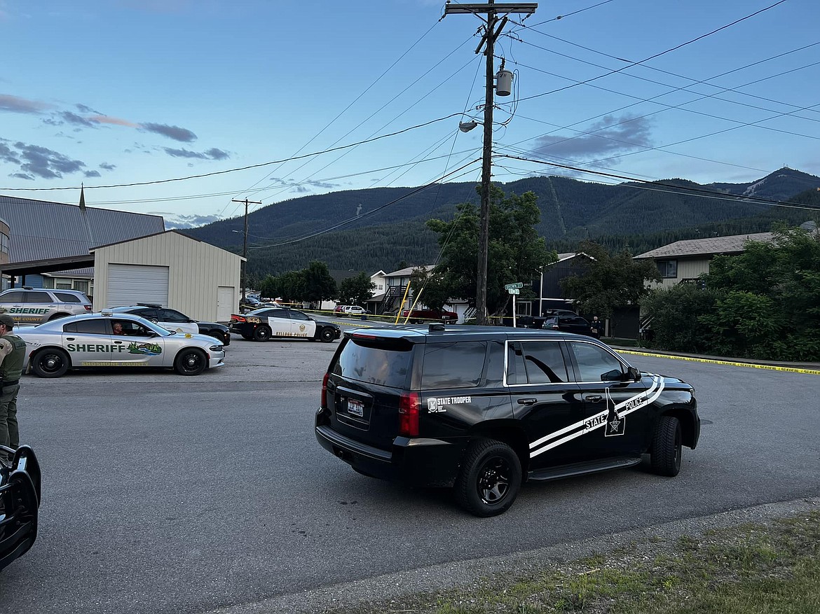 Police and sheriff's office vehicles are near the scene Sunday where four people were found dead of gunshot wounds in Kellogg, Idaho.