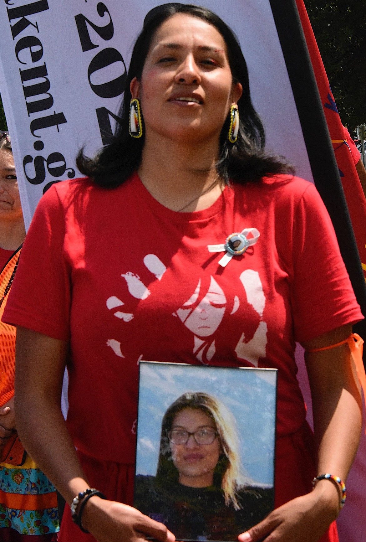 Carissa Heavy Runner, Mika Westwolf's mother, holds a photograph of her daughter and demands answers. (Berl Tiskus/Leader)