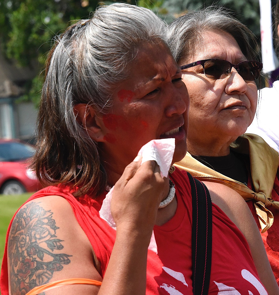 Bonnie Asencio, Marina Two Teeth's mother, cries as she wipes the red handprint from her mouth so she can speak about her daughter's hit-and-run death and ask for the truth. (Berl Tiskus/Leader)