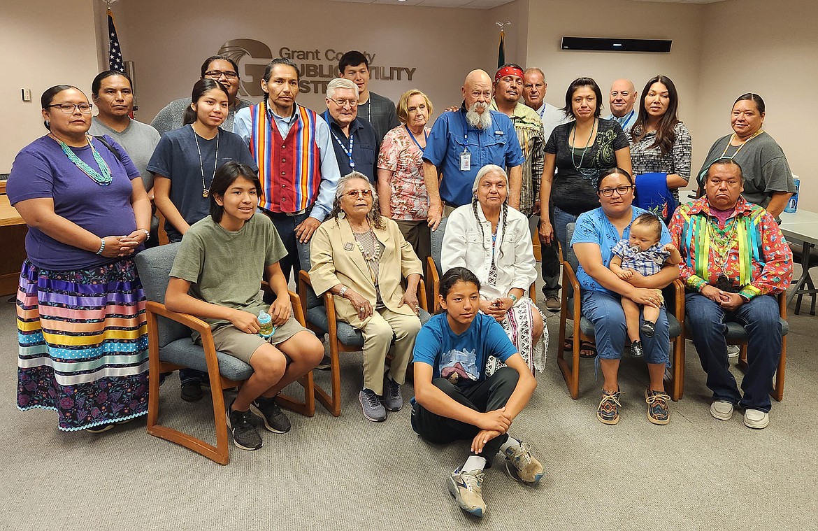 Family members of the late Rex Buck Jr. and Grant County PUD commissioners get together for a picture after Buck was honored with a proclamation from the commissioners. Front row: Rex “Tiny” Buck IV. Second row, from left, Sunsky Buck, Ruth Jim, Angela Buck, Lela Buck holding Elias Corral and Nikkia Owlchild. Third row, from left: Clarice Paul, Lightning Paul, Katrina Buck, Kenny Mathias, Rex Buck III, PUD Commissioner Tom Flint, River Buck, Commissioner Judy Wilson, Commissioner Nelson Cox, Clayton Buck, Commissioner Larry Schaapman, Tasha Bailey, Commissioner Terry Pyle, Alyssa Buck and Emiliee Maurice.