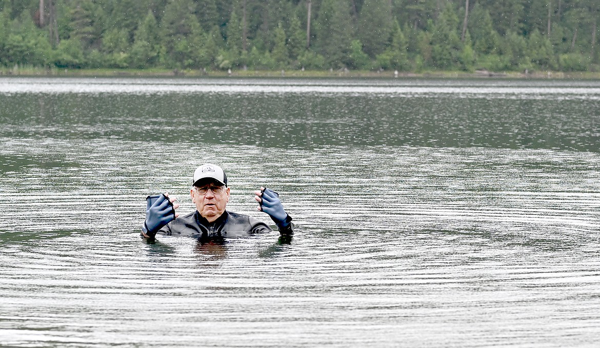 Columbia Falls resident Mike Turner shows off his hand flippers while aqua jogging in Lion Lake recently. He plans to aqua jog the length of Hungry Horse Reservoir next month to raise funds for his church. (Chris Peterson/Hungry Horse News)