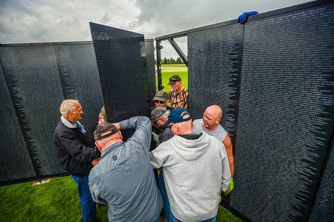 A team of veterans, including five who served in the Vietnam War, carry the final panel and manuever it into place at The Wall That Heals at the Glacier High School soccer fields on Wednesday, June 21. The Wall That Heals is a three-quarter scale replica of the Vietnam Veterans Memorial in Washington D.C. (Casey Kreider/Daily Inter Lake)