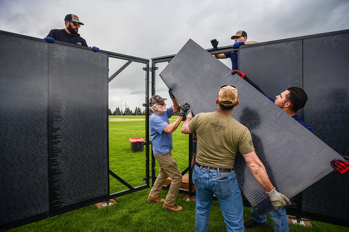 Crews of veterans and volunteers carry the individual panels and manuever them into place at The Wall That Heals at the Glacier High School soccer fields on Wednesday, June 21. The Wall That Heals is a three-quarter scale replica of the Vietnam Veterans Memorial in Washington D.C. (Casey Kreider/Daily Inter Lake)